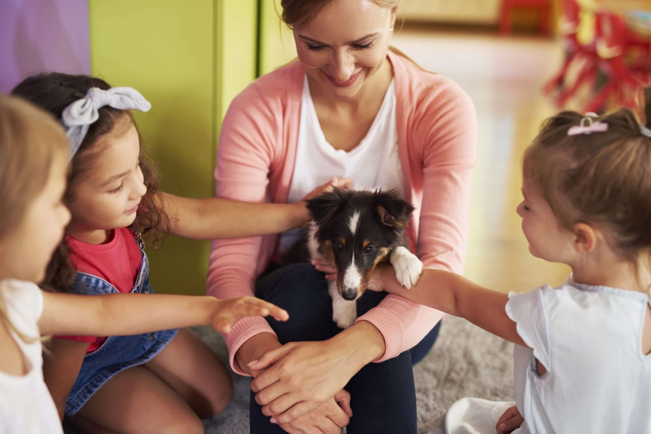 Happy kids stroking cute dog